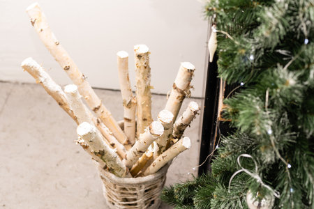New Year decor of the Christmas tree. Wooden box with birch logs, decorated.の写真素材
