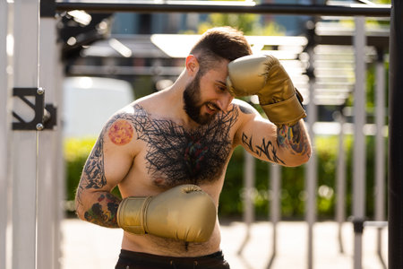 Man in boxing gloves is practicing on an outdoorの写真素材
