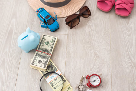 dollars, piggy bank, alarm clock, hat, glasses. Time to go on holiday. Things for summer trip.