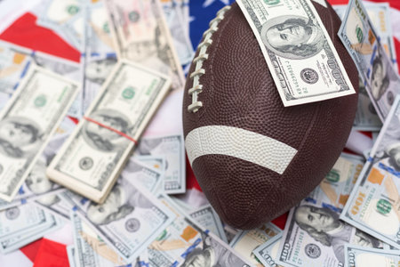 Money and rugby ball on american flag background, closeup. Concept of sports bet