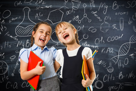 children on the background of formulas, isolated on wall chalk board background. Childhood children kids education lifestyle conceptの写真素材