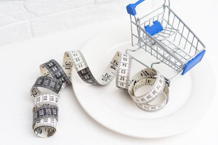 measure tape and mini shopping cart in white plate