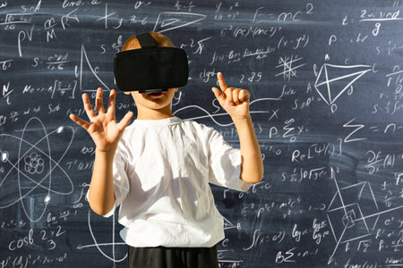 child in virtual glasses on the background of formulasの写真素材
