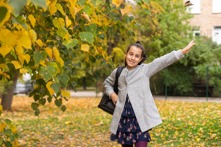 A young teenage girl goes to school with a backpack. A teenage student or a schoolgirl. The concept of education.の写真素材