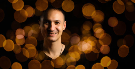 Back silhouette of man isolated on magical background for Halloween with garlands, bokeh lights, hanging glowing pumpkins, smoke. Mystical night forest with jack o lantern. Copy spaceの写真素材