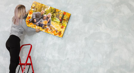 Canvas print with gallery wrap. woman hangs autumn photography, photocanvasの写真素材
