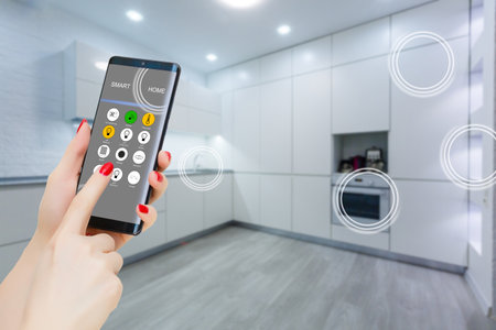 Smart home technology interface on smartphone app screen with augmented reality (AR) view of internet of things (IOT) connected objects in the apartment interior, person holding device.の写真素材