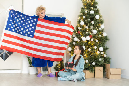 grandmother and granddaughter christmas with usa flagの写真素材