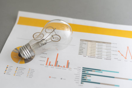 Energy efficiency rating chart, light bulb on gray background, closeupの写真素材