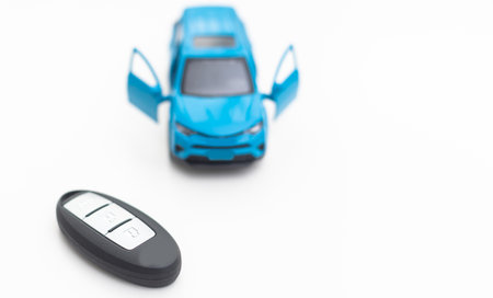 Car key and toy car. Automobile security accessoriesの写真素材