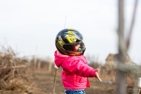 Little girl in a motorcycle helmet.の写真素材