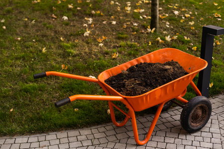 Garden-wheelbarrow filled with soil on a farmの写真素材
