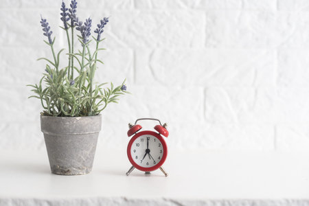 a vase with lavender and an alarm clock