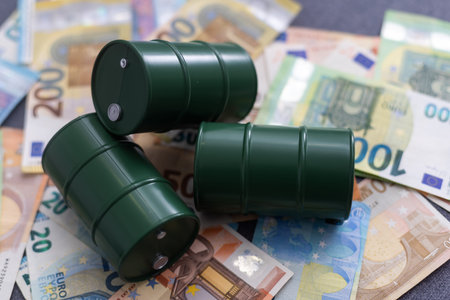oil barrel with money, euro banknotes closeup