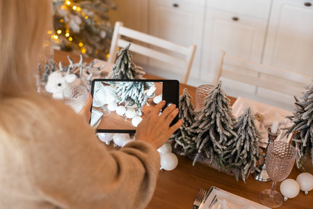 Woman taking a Photo of Christmas Garland.の写真素材