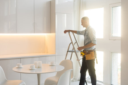 Builder handyman with construction tools. House renovation background.の写真素材
