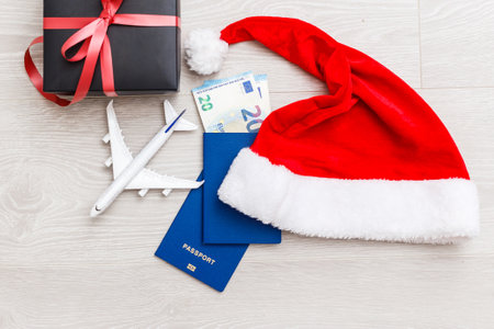 Christmas airplane travel concept. Passports, toy white plane. on gray textured background. Gift boxの写真素材