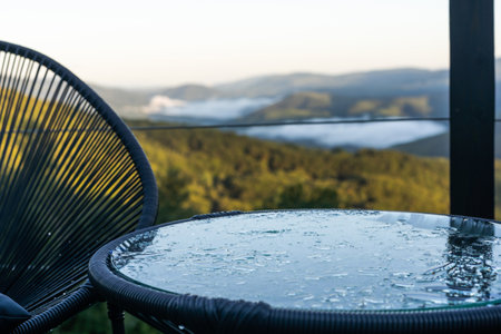 Pattern of water drops in a shiny metallic surface with table reflectionsの写真素材