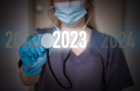 Close up of male doctor hands touching 2023 number on the virtual screen