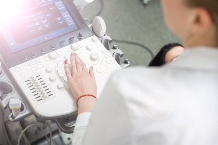 Woman endocrinologist making ultrasonography to a female patient in an ultrasound office. Ultrasound diagnosticsの写真素材