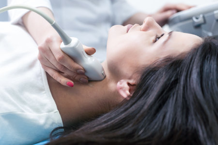 Woman endocrinologist making ultrasonography to a female patient in an ultrasound office. Ultrasound diagnosticsの写真素材