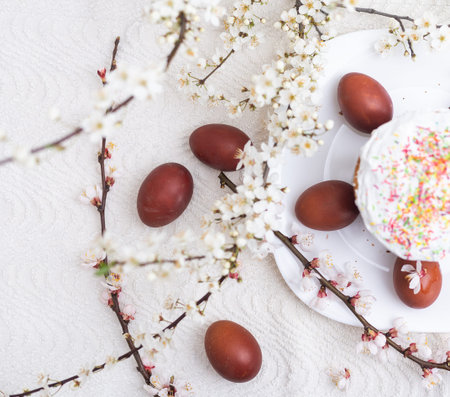 easter cake and red eggs on rustic wooden table. Top view.