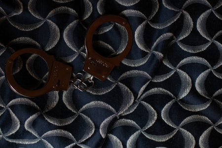 Classic chain handcuffs on black background