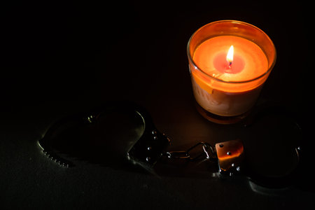 composition with the toy handcuffs, candle.