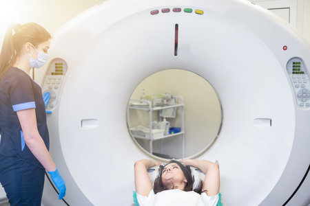 Radiologist with a female patient in the room of computed tomographyの写真素材