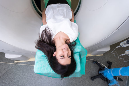 beautiful woman lying on ct scanner bed during tomography test in hospital