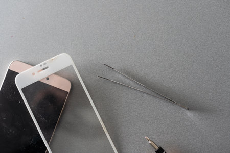 a person places a protective glass or film on a smartphone. copy space.の写真素材