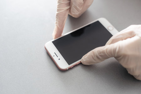 Kiev, Ukraine - December 10, 2022: Close-up iPhone repair, replacement of protective glassのeditorial素材