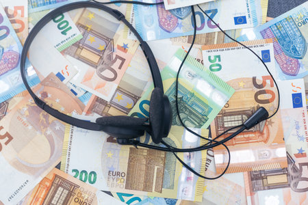 euro banknotes headphones headset. Money and technology still life concept.の写真素材