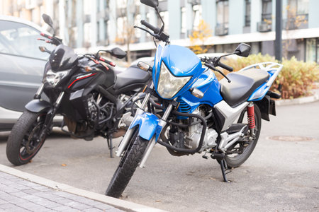 mopeds scooters parked in a row on a street.の写真素材
