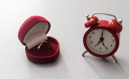 Wedding rings and alarm clock, wedding time concept.