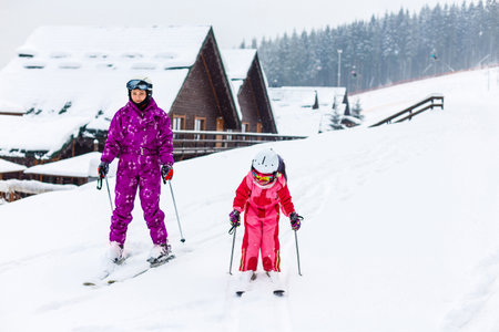 Ski, winter and fun - Family: mother and daughter enjoying winter vacations.の写真素材