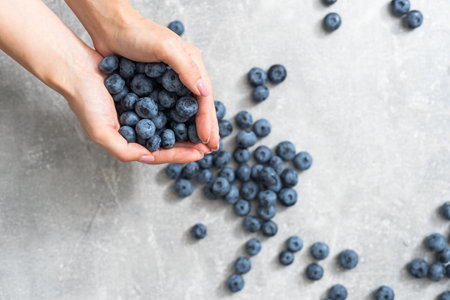 Close-up of hands holding blueberry. Harvest, summer, healthy eating concept.の写真素材