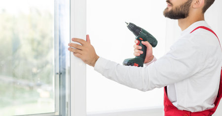 Close up of a mans hand holding screwdriver machine