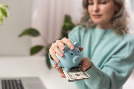 Young woman planning save salary money early years using laptop computer with pig bank save coin.