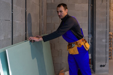 Handsome young man builder installing