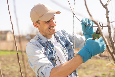 Portrait of young man pruning branchの写真素材