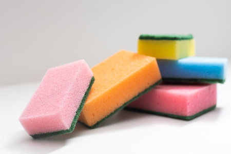 Kitchen dishcloth, cleanup concept, housework. Colorful kitchen sponges for cleaning close-up,...