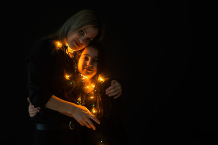 Merry Christmas and Happy Holidays. Mom and daughter with garland
