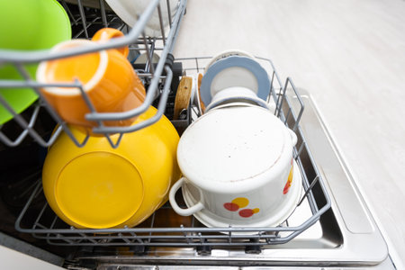 Dishes and cutlery on dishwashing machine. Clean dishes.の写真素材