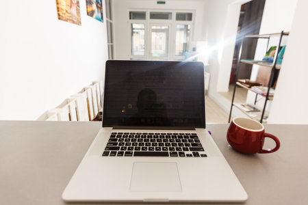 Cropped shot of portable office desk with mock-up computer devices, supplies and decorations on white table.の写真素材