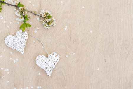 Hanging on symbolic decorative heart on flowering trees. Concept of Valentines day, Spring, Love