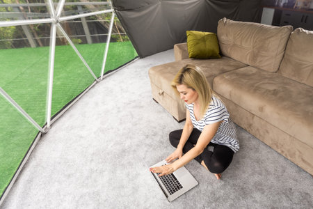 happy middle aged woman using her laptopの写真素材