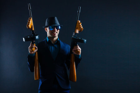 businessman in sunglasses and with a machine gun.