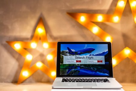 lights online booking and reservation. Search flights on a computer laptop screen, office desk backgroundの写真素材