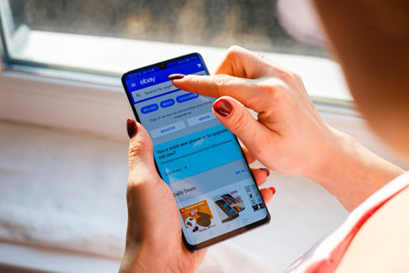 eBay, on the screen smartphone. Closeup mobile applications for shopping, e-commerce. Kyiv, Ukraine...